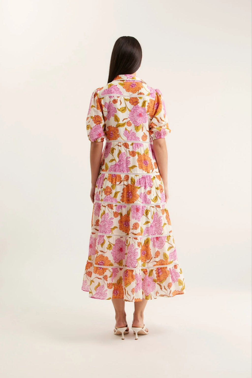 Woman wearing a floral dress on a white background