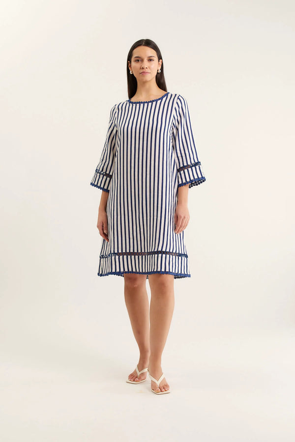 Woman wearing a blue and white striped dress on a white background