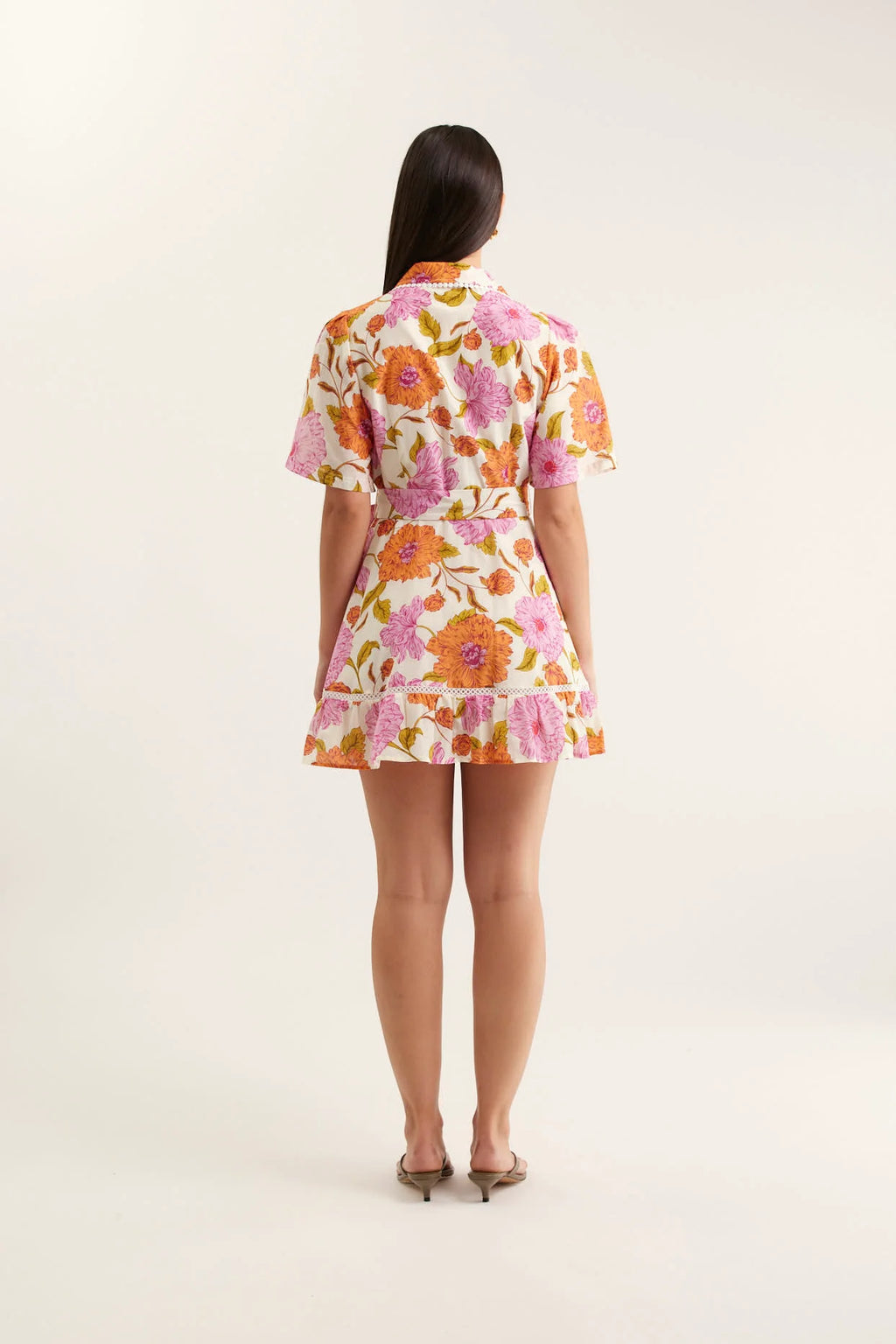 Woman wearing a floral dress on a white background