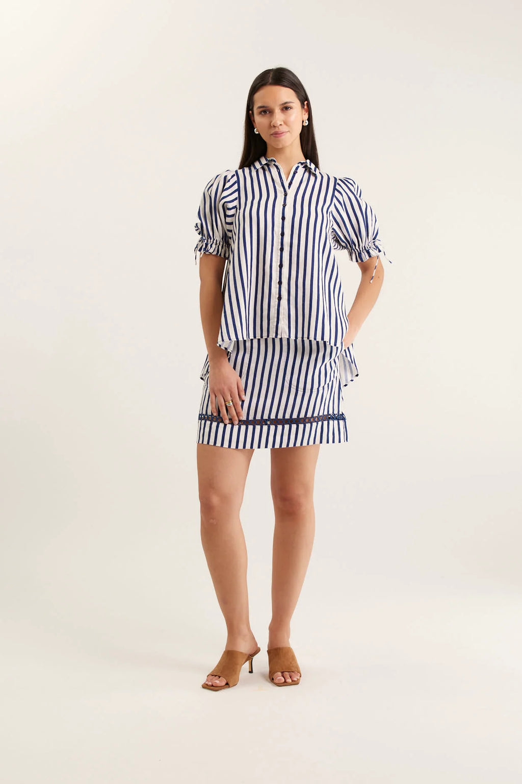 Woman wearing a striped dress on a white background