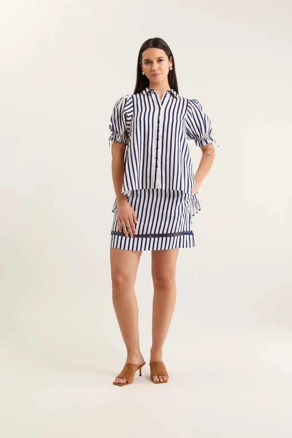 Woman wearing a striped dress on a white background