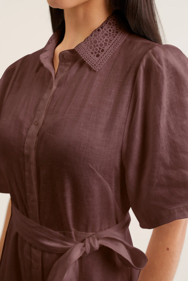 Brown dress with a patterned collar on a neutral background