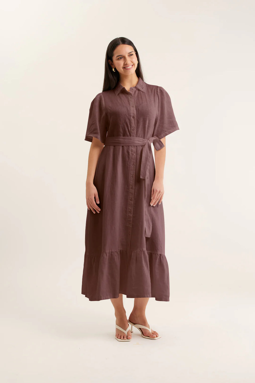 Woman wearing a brown dress on a white background