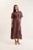 Woman wearing a brown dress on a white background
