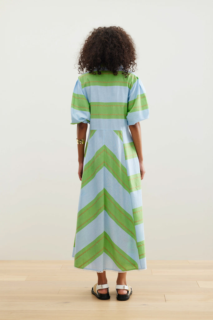 The Legend of San Blas Dress from Binny features yarn dye sky blue and grass green cotton poplin stripes with a tiny wiggle of orange, finished with cotton crochet lace trim.