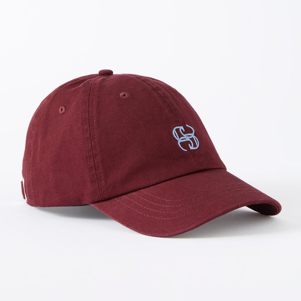 Maroon cap with a logo on a white background