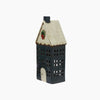 Decorative house-shaped lantern with a white roof and black body on a white background