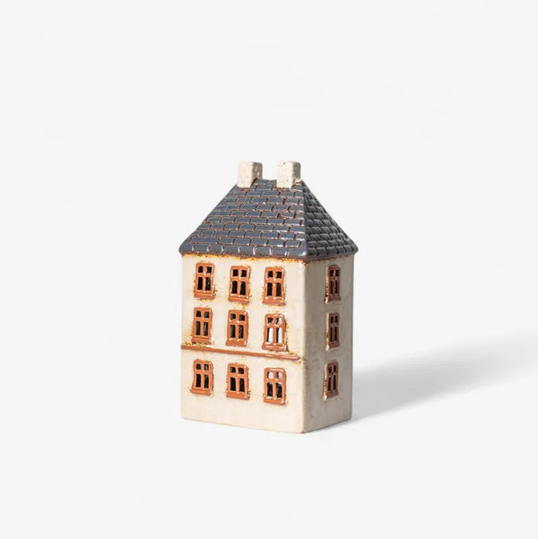 Small model of a house with a gray roof on a white background