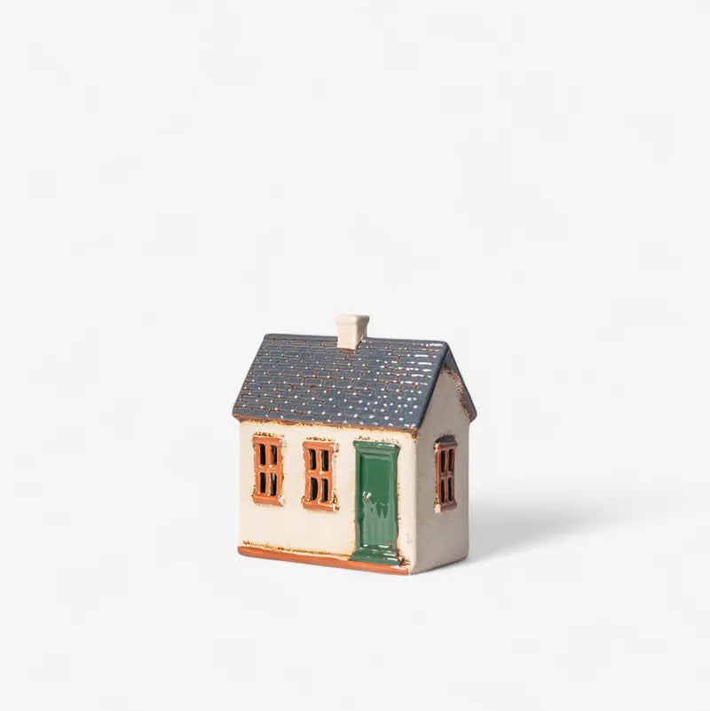Small model of a house with a gray roof on a white background