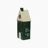 Decorative house-shaped lantern with a green base and white roof on a white background