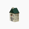 Small decorative house with a green roof on a white background