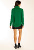 Person wearing a green sweater and black skirt on a white background