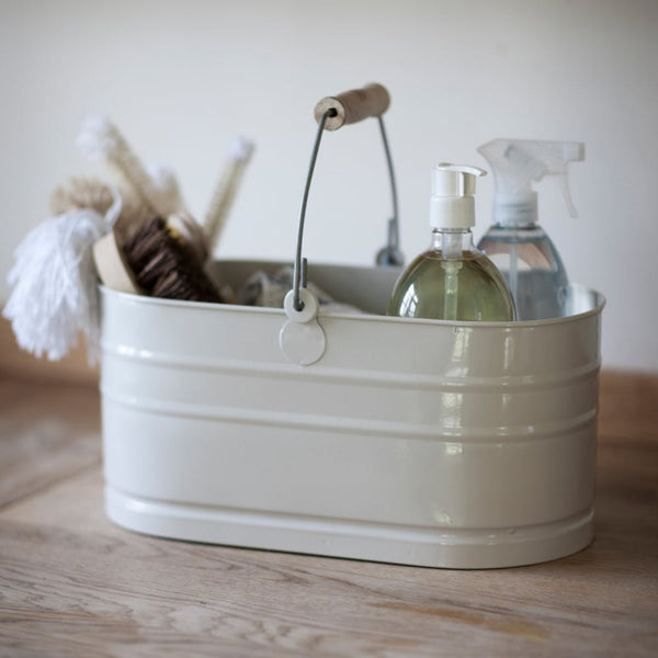 cream coloured oval metal bucket holding cleaning products and equipment