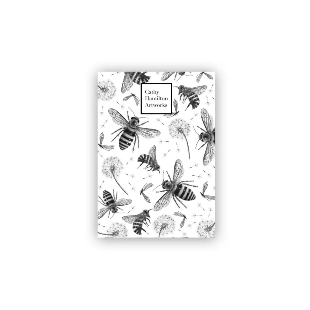 White A6 note pad with black pencil drawings of bees and dandelions drawn by australian artist cathy hamilton