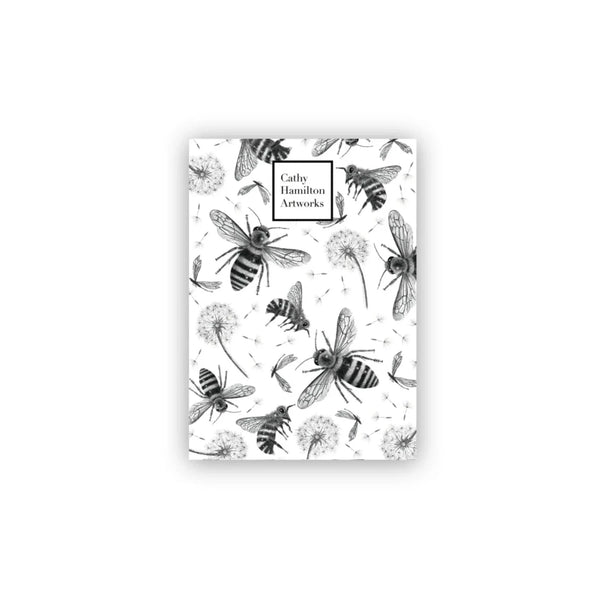 White A6 note pad with black pencil drawings of bees and dandelions drawn by australian artist cathy hamilton