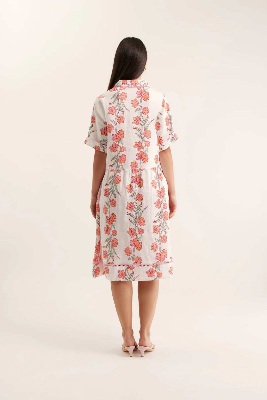 Woman wearing a floral dress on a white background