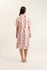 Woman wearing a floral dress on a white background